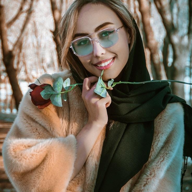 Kaveri Mehta, Lead Design Curator at VaultQuartzPlume, reviewing corporate floral arrangements